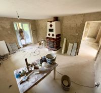 Interior of a family house with a fireplace and preparation for renovation.