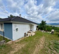 A family house in Ružiná with a grassy plot and a view of the surrounding countryside.