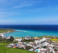 The coast of Agia Eirini with a view of the blue sea and green surroundings.