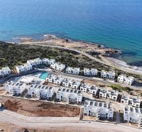 View of the coastal residential area in Agia Eirini with seaside apartments.