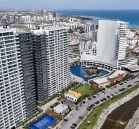 Apartment buildings and coastline in Agia Eirini, the surroundings are adorned with residential complexes.