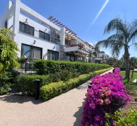 A building with a garden and flowers in the city of Agia Eirini, ideal for a 2-bedroom apartment.