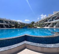 The apartments in Agia Eirini are surrounded by a large pool with clear blue water.