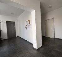 Common areas with an elevator and staircase in a building with a one-room apartment.