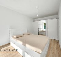A bedroom in a two-room apartment with a wood-patterned floor and white furniture.