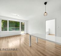Interior of a 2-room apartment with a wooden decor floor and a large window.