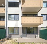 A building with balconies and a green barrier near a 2-room apartment in Dunajská Lužná.