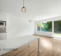 A bright interior of a 2-room apartment with wood-patterned flooring and large windows.