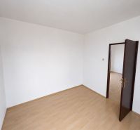 A room with a wooden floor decor and white walls in a 3-room apartment.
