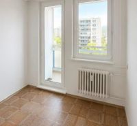 A room in a 3-room apartment with a wooden decor floor and a view of the city.