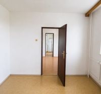 A white interior in a 3-room apartment with doors and a window.