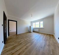Living room in a three-room apartment with a wooden decor floor.