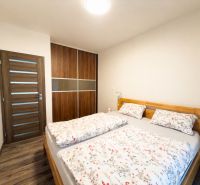 A bedroom in a 3-room apartment with a double bed and a built-in wardrobe.