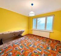 Yellow walls, colorful carpet, storage space in a 4-room apartment.