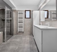 A bathroom in a family house with a bathtub, shower, and double sink.