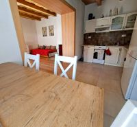 A kitchen and dining table with a wooden decor in a family house.