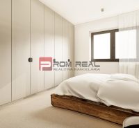 A bedroom in a 3-room apartment with a bed and built-in wardrobes.