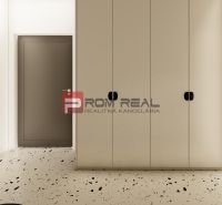 Entrance hall of a 3-room apartment with large wardrobes and light terrazzo flooring.