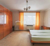 How does the interior of a bedroom with wallpaper, wardrobes, and a bed in a family house look?