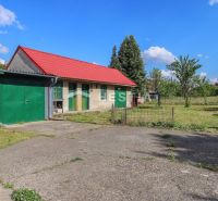 A family house in Borský Mikuláš with a grassy garden and a red roof.