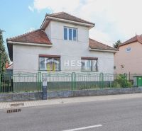 A family house in Borský Mikuláš with a red tile roof and a green fence.