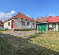 A family house in Borský Mikuláš with a garden and a garage on a grassy plot.