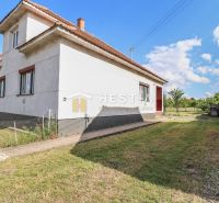 A family house in Borský Mikuláš with a grassy plot and a blue sky.