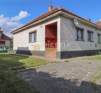 A family house in Borský Mikuláš with a landscaped lawn, paved area, and satellite dish.