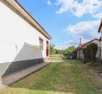 A view of the backyard of a family house in Borský Mikuláš with a grassy area.