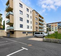 An apartment building on Letná Street in Stará Ľubovňa with parking spaces in front of the building.