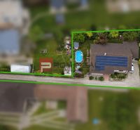 A family house in Senec with a swimming pool and solar panels on the roof.