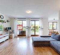 Living room in a family house with a spacious sofa and a floor with a wooden decor.