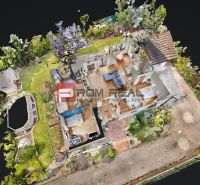 A family house in Hrubý Šúr with a wooden decor floor and a swimming pool in the garden.