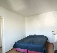 Bedroom in a 2-room apartment with a bed and IKEA furniture. Floor with wood decor.