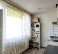 A kitchen in a 2-room apartment with a window, a simple kitchenette, and practical storage spaces.