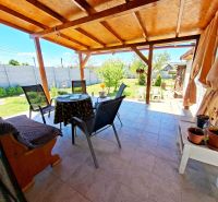 The terrace of a family house in Jasová with a view of the garden and comfortable seating.