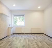 Offices with a pastel wall, a sink, and a wood-patterned floor.