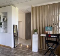 Commercial premises with a wooden decor floor, shelves, and cosmetic products.