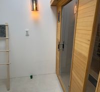 Interior with a wooden sauna and light, commercial spaces.