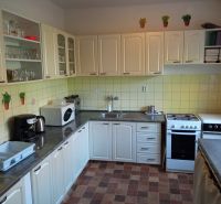 Hotel and guesthouse kitchen with white cabinets and equipment.