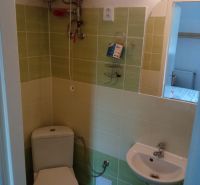 Bathroom with toilet, sink, and boiler in hotels and guesthouses.