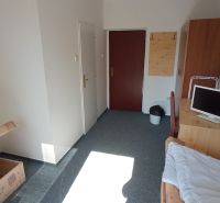 A simple room with a bed, a table, and a television in hotels and guesthouses.