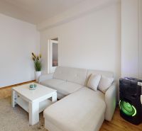 Bright 1-bedroom apartment on K výstavisku Street, with a comfortable sofa and modern amenities.