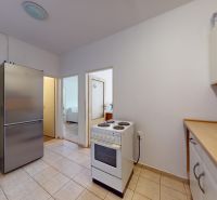 The kitchen of the 2-room apartment on K výstavisku street has white kitchen cabinets.