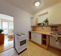 2-room apartment on K výstavisku street with a simple kitchen and wooden floors.