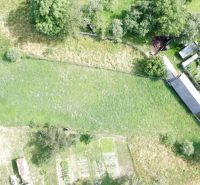 Aerial view of residential plots in Vlachovo with grassy area and garden.