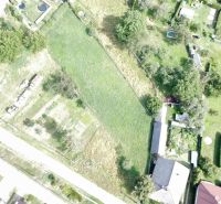 Aerial view of residential plots in Vlachovo with greenery and gardens.