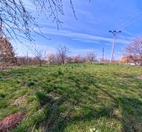 A green plot with power lines and trees on Korytovská Street in Lužianky, ideal for commercial land.