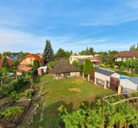 Gardens of family houses on Hlavná Street in Lehota with plenty of greenery.