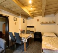 A traditional interior in a family house with simple furniture and wooden decorations.